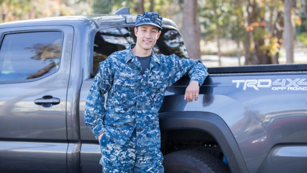 Military car buying, Navy sailor in front of new truck